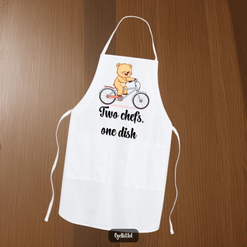 Funny apron depicting a determined bear cub balancing on a tiny tandem bike, perfect for a humorous kitchen adventure.