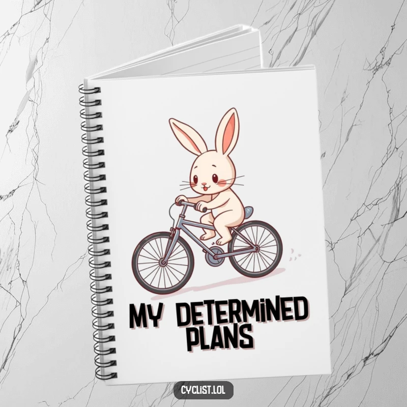 Funny determined rabbit character pedaling a tiny bicycle uphill on a notebook cover, inspiring determined thoughts and goal-setting.