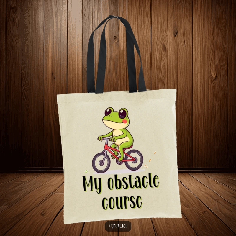 Funny frog tote bag showcasing a playful frog expertly riding a bicycle over tiny obstacles, a practical accessory for outdoor enthusiasts.